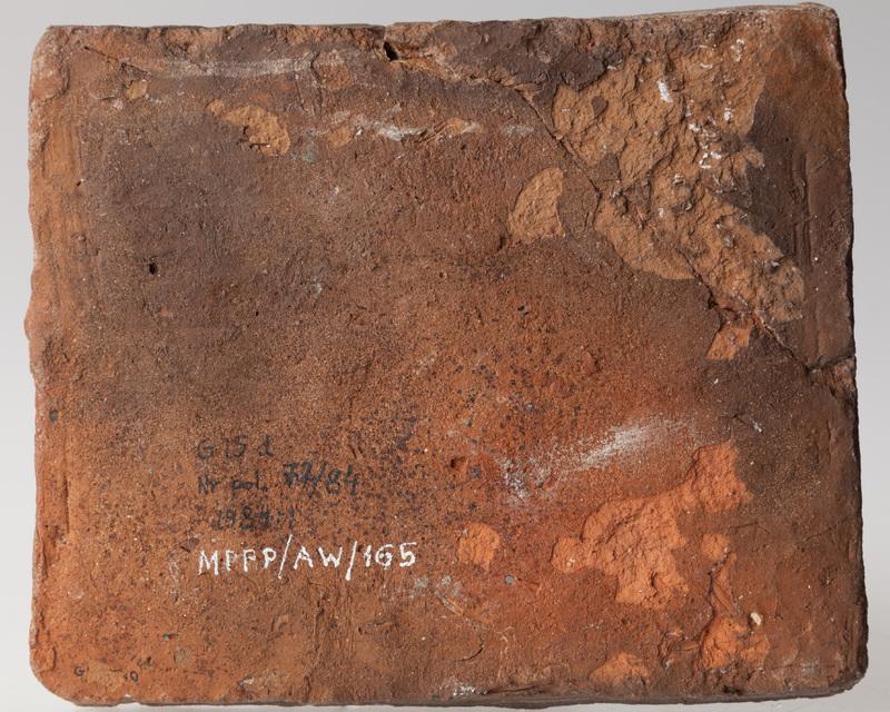 Płytka przedstawiająca mężczyznę trzymającego lwa na arkanie